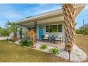 Inviting front porch with seating, colorful plants, and a freshly painted blue door that enhance curb appeal at 5901 1St Ne St, St Petersburg, FL 33703