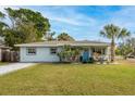 Attractive single-story home with a well-maintained lawn, mature trees, and inviting curb appeal at 5901 1St Ne St, St Petersburg, FL 33703
