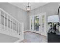 Bright entryway with staircase, wood-look floors, and access to backyard at 6323 Vista Verde E Dr, St Petersburg, FL 33707