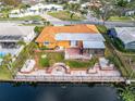 House with canal access, backyard patio, and lush landscaping at 6888 121St N St, Seminole, FL 33772