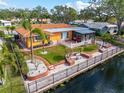 Backyard oasis with canal views, brick patio, and tropical landscaping at 6888 121St N St, Seminole, FL 33772