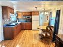 Eat-in kitchen with wood cabinets and laminate floors at 9790 66Th N St # 330, Pinellas Park, FL 33782