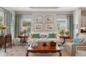 Bright living room with white sofa, wooden coffee table, and wall art at 10025 Lake Wales Cir, Sarasota, FL 34241