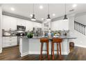 Bright kitchen featuring white cabinets, granite countertops, pendant lighting, and stainless steel appliances at 1003 Starboard Ct, Oldsmar, FL 34677