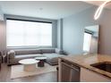 Stylish living room boasts a modern sectional sofa and view of the kitchen at 1120 E Kennedy Blvd # 1225, Tampa, FL 33602