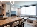 Open-concept living room featuring a granite kitchen island and modern sectional at 1120 E Kennedy Blvd # 1225, Tampa, FL 33602