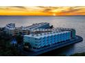 Aerial view of waterfront condo building at sunset at 2506 N Rocky Point Dr # 208, Tampa, FL 33607