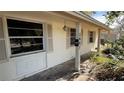 A beige house exterior with shutters and a small front porch at 5641 1St Ne St, St Petersburg, FL 33703