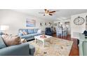 Living room with light blue sofa, white coffee table, and hardwood floors at 5705 80Th N St # 214, St Petersburg, FL 33709