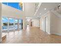 Spacious living room with tile flooring, water view and large windows that let in plenty of natural light at 6015 Kipps Colony E Dr, Gulfport, FL 33707