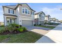 Houses with gray siding and gray garage doors in a row at 8280 Rolling Tides Dr, New Port Richey, FL 34655