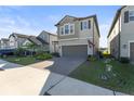 Two-story house with gray siding, gray garage door, and landscaped front yard at 8280 Rolling Tides Dr, New Port Richey, FL 34655
