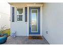 Modern front door with glass panels and black shutters at 8280 Rolling Tides Dr, New Port Richey, FL 34655