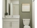 Modern bathroom with white vanity and green walls at 8439 Bella Mar Trl, Parrish, FL 34219