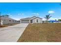 New construction home with gray siding, and a two-car garage at 110 Lilyan Ct, Rotonda West, FL 33947