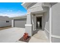 Open front door reveals the interior of the home at 110 Lilyan Ct, Rotonda West, FL 33947