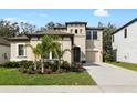 Beautiful two-story home with a well-manicured lawn and tasteful landscaping, including small palm trees at 14672 Horse Trot Rd, Lithia, FL 33547