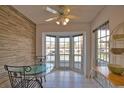Bright breakfast nook features tile flooring, a ceiling fan, and a charming bay window with views at 201 Silver Lake Dr # 204, Venice, FL 34292