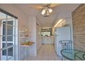 Kitchen with white cabinets, tile flooring, breakfast nook and a pass through to the kitchen sink at 201 Silver Lake Dr # 204, Venice, FL 34292