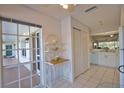 Clean kitchen with white cabinets, tile flooring, and adjacent breakfast nook with lots of natural light at 201 Silver Lake Dr # 204, Venice, FL 34292