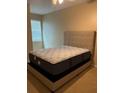 Bedroom with a large bed and neutral decor at 2010 E Palm Ave # 14215, Tampa, FL 33605