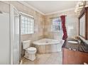 Bathroom featuring a corner jacuzzi tub, shower, and granite vanity at 2201 30Th N Ave, St Petersburg, FL 33713