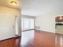 Bright living room with hardwood floors and access to the kitchen at 23315 Charlston Pl, Land O Lakes, FL 34639