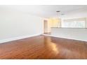 Spacious living room with hardwood floors and a half wall at 23315 Charlston Pl, Land O Lakes, FL 34639