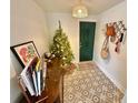 Bright entryway with patterned flooring, a Christmas tree, and coat rack at 3409 Tarlton N St, St Petersburg, FL 33713
