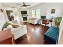 Living room featuring hardwood floors, a fireplace, and ample seating at 3409 Tarlton N St, St Petersburg, FL 33713
