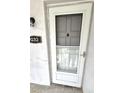 White front door with gray door and screen at 3815 N Oak Dr # G32, Tampa, FL 33611