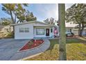 Charming single-story home with well-maintained landscaping and an American flag at 4116 Ohio Ave, Tampa, FL 33616