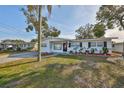 Charming single-story home with manicured landscaping and a patriotic American flag at 4116 Ohio Ave, Tampa, FL 33616