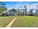 Expansive backyard featuring lush greenery and mature trees, offering a serene and private outdoor space at 4501 Keene Rd, Plant City, FL 33565