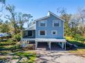 Charming two-story home featuring a screened porch, covered carport, and well-maintained landscaping at 4501 Keene Rd, Plant City, FL 33565