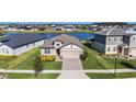 Property view showcasing the house's location by a lake and other houses at 7122 Heron Walk Ln, Wesley Chapel, FL 33545