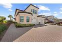 Two-story townhome with a two-car garage and manicured landscaping at 10043 Crooked Creek Dr # 101, Venice, FL 34293