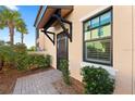 Inviting front entrance with a screen door and landscaping at 10043 Crooked Creek Dr # 101, Venice, FL 34293