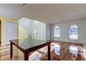 Open concept living space with hardwood floors and a view of the kitchen at 11309 Outrigger Ave, Spring Hill, FL 34608