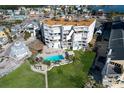 Great aerial view of this condo building with community pool, lush landscaping, and fantastic views at 17980 Gulf Blvd # 103, Redington Shores, FL 33708