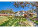 Side view of a villa showcasing its landscaping and walkway at 2035 Nash Dr, Clearwater, FL 33763