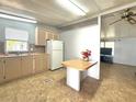 Functional kitchen featuring white appliances and room for a small table at 225 N Saint Thomas Cir, Apollo Beach, FL 33572