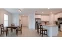 Bright kitchen featuring stainless steel appliances, granite counters, and an open-concept design at 22547 Storybook Cabin Way, Land O Lakes, FL 34637