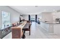 Open-concept dining room with a view, seamlessly connected to the kitchen and living area at 5513 Rainwood Meadows Dr, Apollo Beach, FL 33572
