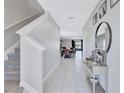 Inviting hallway with tile flooring and stylish decor leads to a bright and airy living space at 5513 Rainwood Meadows Dr, Apollo Beach, FL 33572