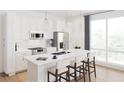 Modern kitchen with white cabinets, island, and stainless steel appliances at 600 3Rd S Ave # 405, St Petersburg, FL 33701