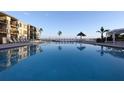 Refreshing community pool with lounge chairs and waterfront views at 6372 Palma Del Mar S Blvd # 705, St Petersburg, FL 33715