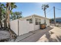 Light gray house exterior with a white fence and driveway at 820 Gulf Blvd # S 1-3, Indian Rocks Beach, FL 33785