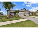 Two-car garage, paver driveway, and lush landscaping at 19315 Hawk Valley Dr, Tampa, FL 33647