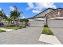 Two-car garage, paver driveway, and beautifully landscaped yard at 19315 Hawk Valley Dr, Tampa, FL 33647